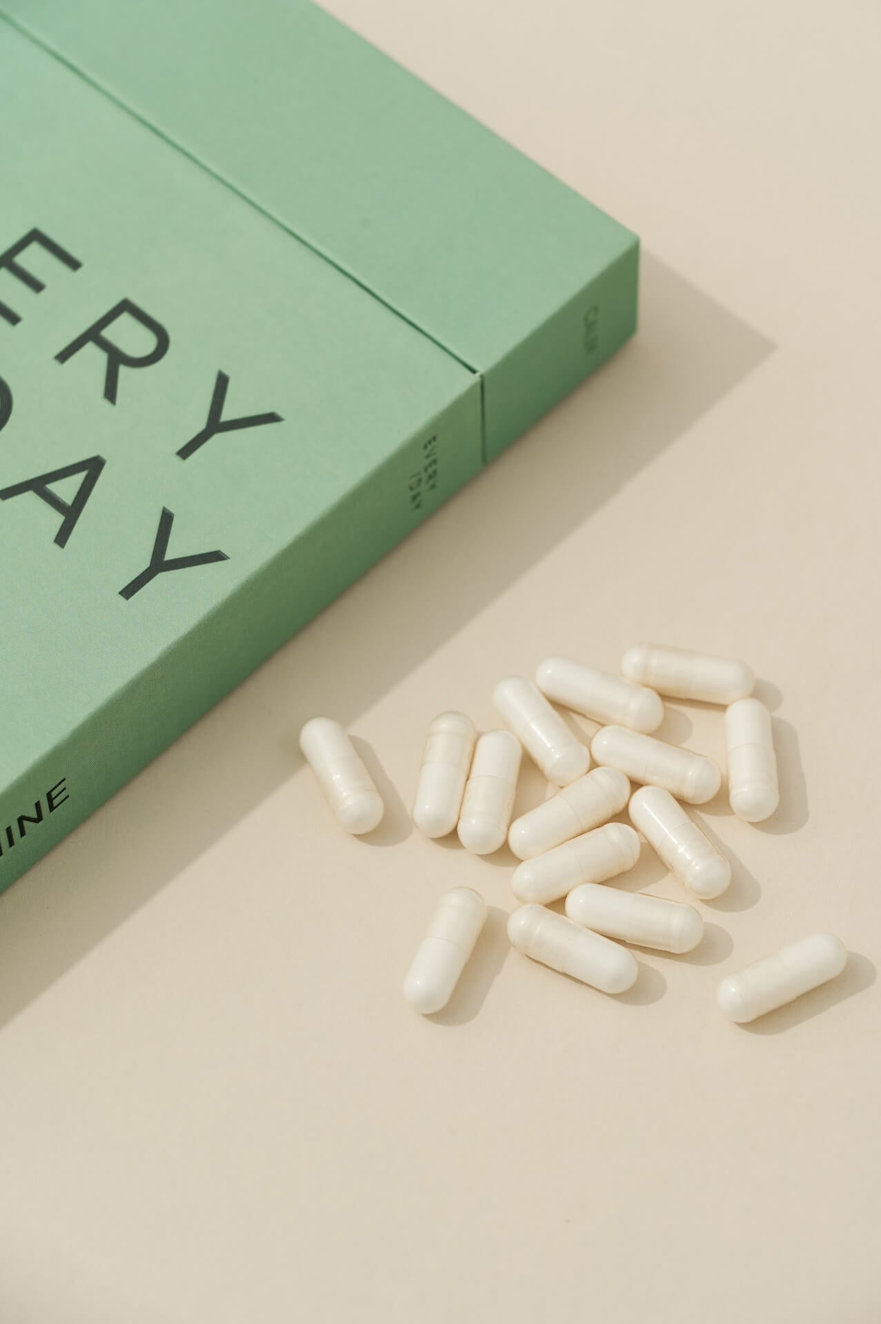 L-Theanine capsules displayed beside an Everyday Supplements box on a light, minimal background.